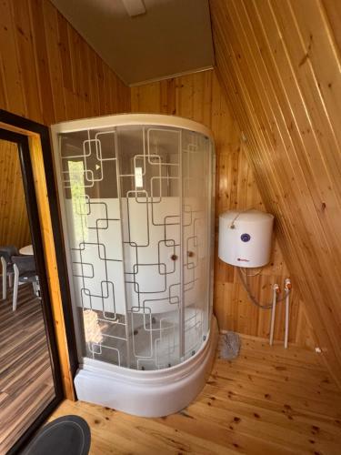 a sauna with a window in a wooden cabin at Lerik kirayə ev in Lerik