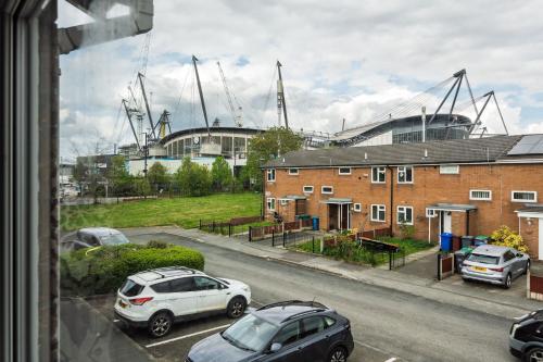 a view from a window of cars parked on a street at Boutique 3bd Opposite Etihad & Coop - Free Parking - Pool Table in Manchester