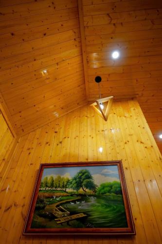 a painting on a ceiling in a wooden room at Bungalow Ven Sông in Ấp Phú Hòa (2)