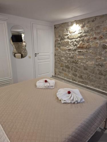 a bedroom with a bed with towels on it at Patriko Stone House in Fourka