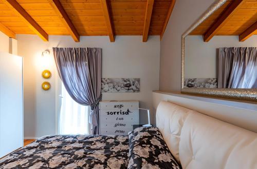 a bedroom with a bed and a mirror at Antico Borgo Monregale in Mondovì