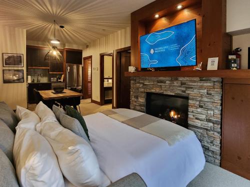 a large bed in a living room with a fireplace at Tremblant Prestige - Étoile 1520-2 in Mont-Tremblant