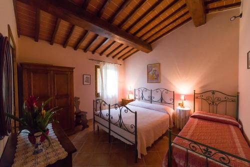Katil atau katil-katil dalam bilik di Agriturismo Le Balze