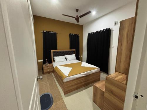 a bedroom with a bed and a ceiling fan at Villa 65 - Eco Village - No Alcohol Zone in Yelagiri