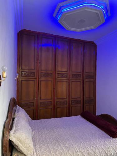 a bedroom with a bed with a blue ceiling at Agréable maison près de la plage in Aglou