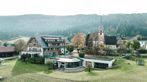 an aerial view of a large building with a church at Löckerwirt in Sankt Margarethen im Lungau