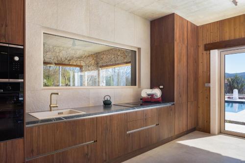 a kitchen with a sink and a window at NEW! Contemporary Villa Fantazija – A Luxurious Retreat in Dicmo in Dicmo