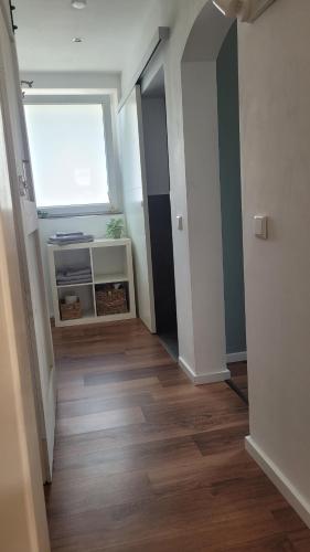 a room with a hallway with a window and wooden floors at TinyWohnung im Pott in Castrop-Rauxel