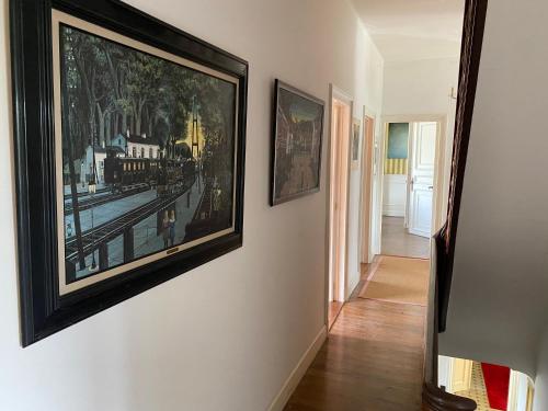 a hallway with two framed paintings on a wall at Walden in Lo-Reninge