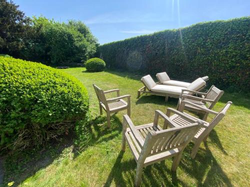 a group of chairs and a couch in the grass at Walden in Lo-Reninge