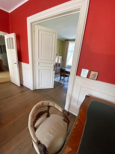 a room with a red wall with a basket in a room at Walden in Lo-Reninge