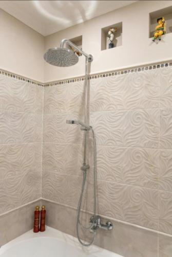 a shower in a bathroom with a shower head at New two bedroomJurmala apartment in Jūrmala