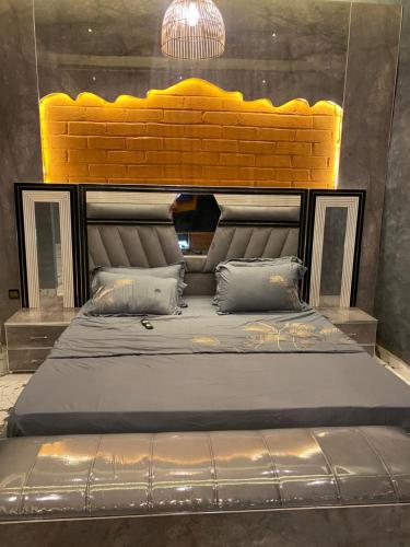 a large bed with a yellow headboard in a room at Keur lumières in Dakar