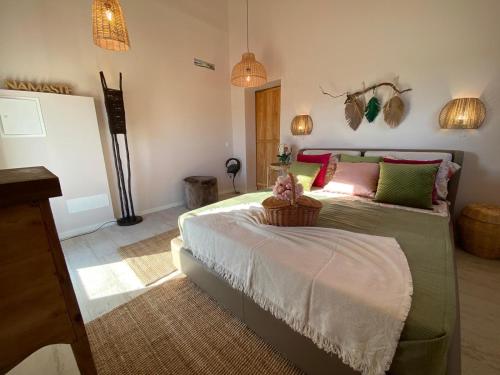 a bedroom with a bed with a basket on it at Portugals Infinity Eco Suite Resort in Tavira