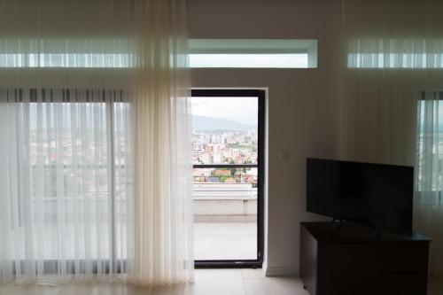 a room with a window with a view of a city at Resident Apartments Nota in Skopje