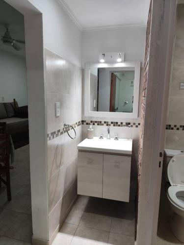 a bathroom with a sink and a toilet and a mirror at B&Z Departamentos in Federación