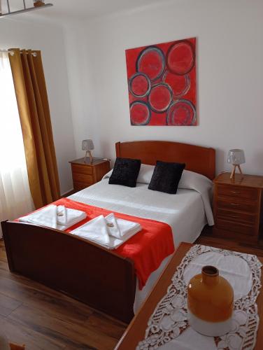 a bedroom with a bed with two towels on it at Saint Peter´s House in Angra do Heroísmo