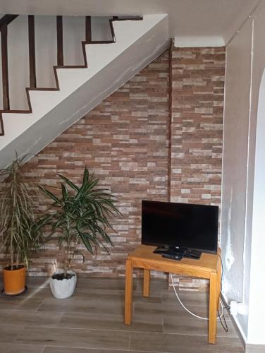 a living room with a tv and a table at Saint Peter´s House in Angra do Heroísmo
