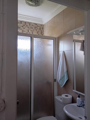 a bathroom with a shower and a toilet and a sink at Saint Peter´s House in Angra do Heroísmo