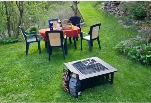 a table with chairs and a table with a solar cooker at Chata Alaska in Jáchymov