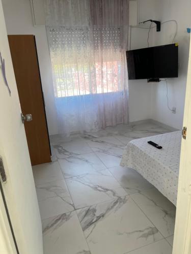 a room with a white marble floor and a door at villa Cristalina in Montevideo