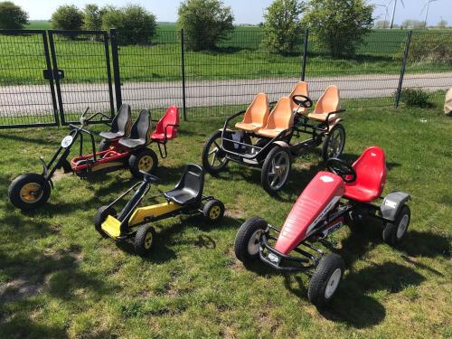 a group of tricycles parked in the grass at The Fehmarn Lodges - OASIS - in Fehmarn