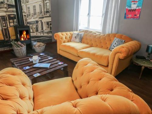 a living room with two couches and a fireplace at Sailaway in Carbis Bay