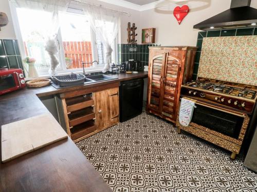 a kitchen with a stove and a counter top at Sailaway in Carbis Bay
