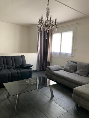 - un salon avec deux canapés et un lustre dans l'établissement Appartement Moderne Centre Port Résidence Port Richelieu 1, au Cap d'Agde