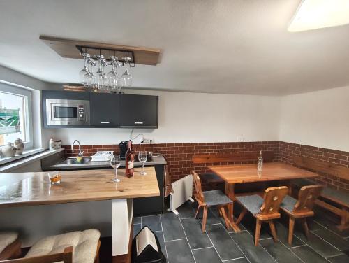 a kitchen with a table and some chairs and a counter at Penzion - sklipek Otáhalovo in Čejkovice
