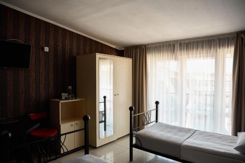 a bedroom with a bed and a window at Hotel Plazma in Lviv