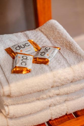 a pile of towels with two bottles of soap at Casas Urbanas Apart Hotel in Jesús María