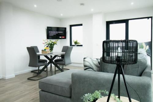 a living room with a couch and a table at Beautiful 3Bed Flat in Belfast City Centre in Belfast