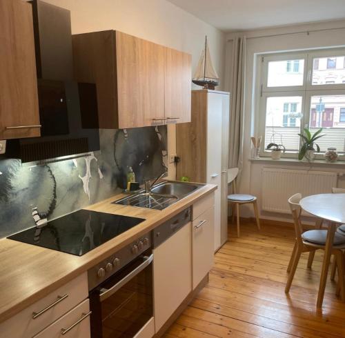 a kitchen with a sink and a stove top oven at Altstadt Ferienwohnung in Brandenburg an der Havel