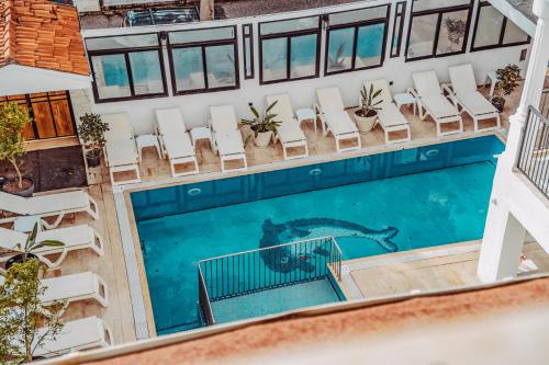 an aerial view of a swimming pool with chairs and a mermaid at The Lume Boutique Hotel & Restaurant & Spa in Bodrum City