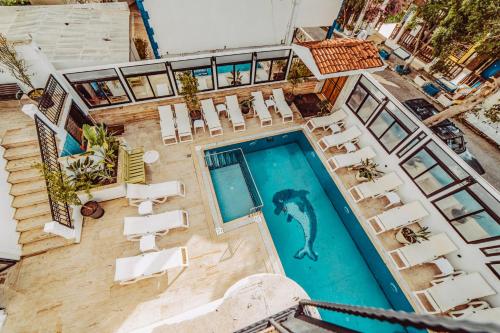an overhead view of a swimming pool with chairs and a mermaid at The Lume Boutique Hotel & Restaurant & Spa in Bodrum City
