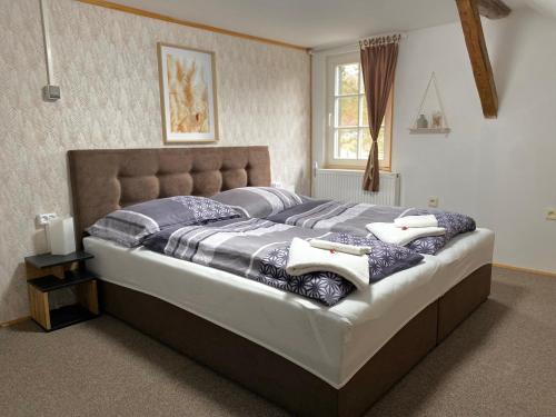 a bedroom with a large bed with pillows on it at Chalupa Laura in Bublava