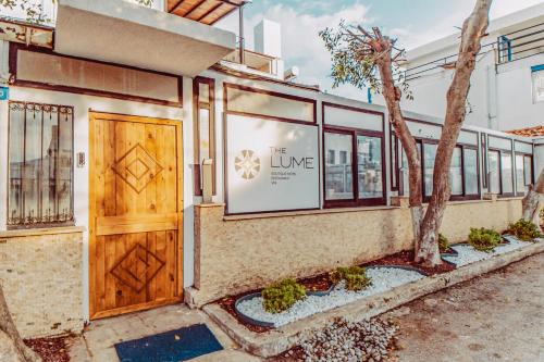 a building with a door and a sign that reads live at The Lume Boutique Hotel & Restaurant & Spa in Bodrum City
