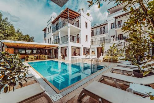 an exterior view of a building with a swimming pool at The Lume Boutique Hotel & Restaurant & Spa in Bodrum City