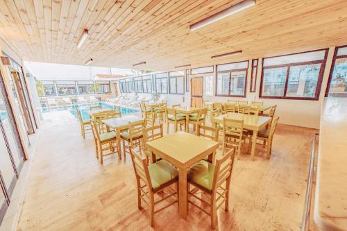a dining room with wooden tables and chairs at The Lume Boutique Hotel & Restaurant & Spa in Bodrum City