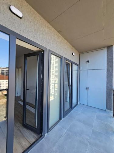 a room with sliding glass doors in a building at Cozy & Modern Studio in Tbilisi City