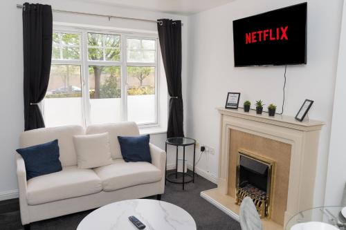 a living room with a white couch and a fireplace at PARKING Luxe City Centre Sleeps 4 NEW in Wolverhampton
