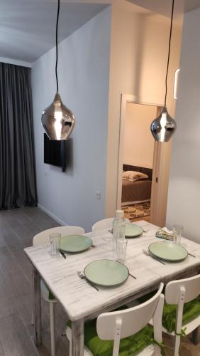 a dining room with a table with green plates at Kalinin 245 in Dilijan