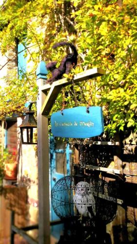 a bird sitting on top of a bird feeder at Maison avec jardin en plein coeur de la Gacilly in La Gacilly