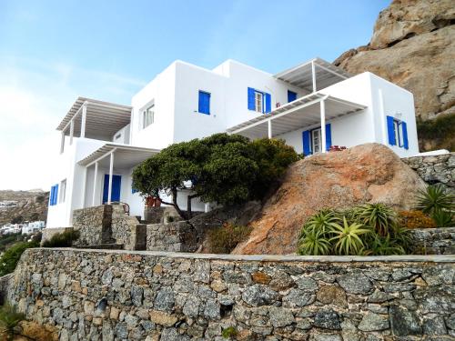 a white house on top of a rock at Villa Oceania in Tourlos