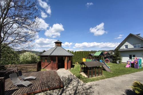 a backyard with a gazebo and a playground at Apartaments Gory in Niedzica Zamek