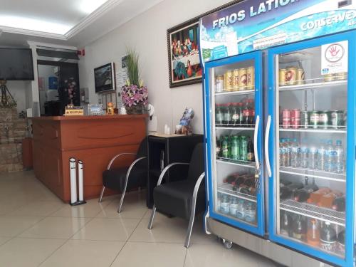 a store with a refrigerator filled with drinks at Hotel Aparecida do Norte in Aparecida