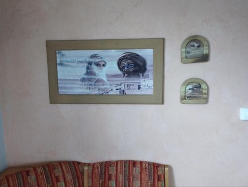 a picture hanging on a wall above a bed at Ferienwohnung Sowade in Nebra