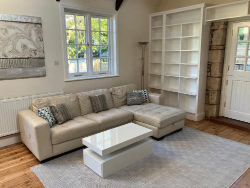 a living room with a couch and a coffee table at Lovely cottage in Penryn centre with parking in Penryn