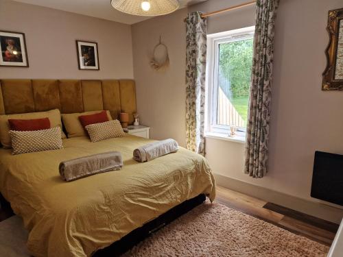 a bedroom with a bed and a window at The Drey by Blake view holidays, a peaceful boutique retreat, 3 miles from Ennerdale- small twin or king bed available in Arlecdon